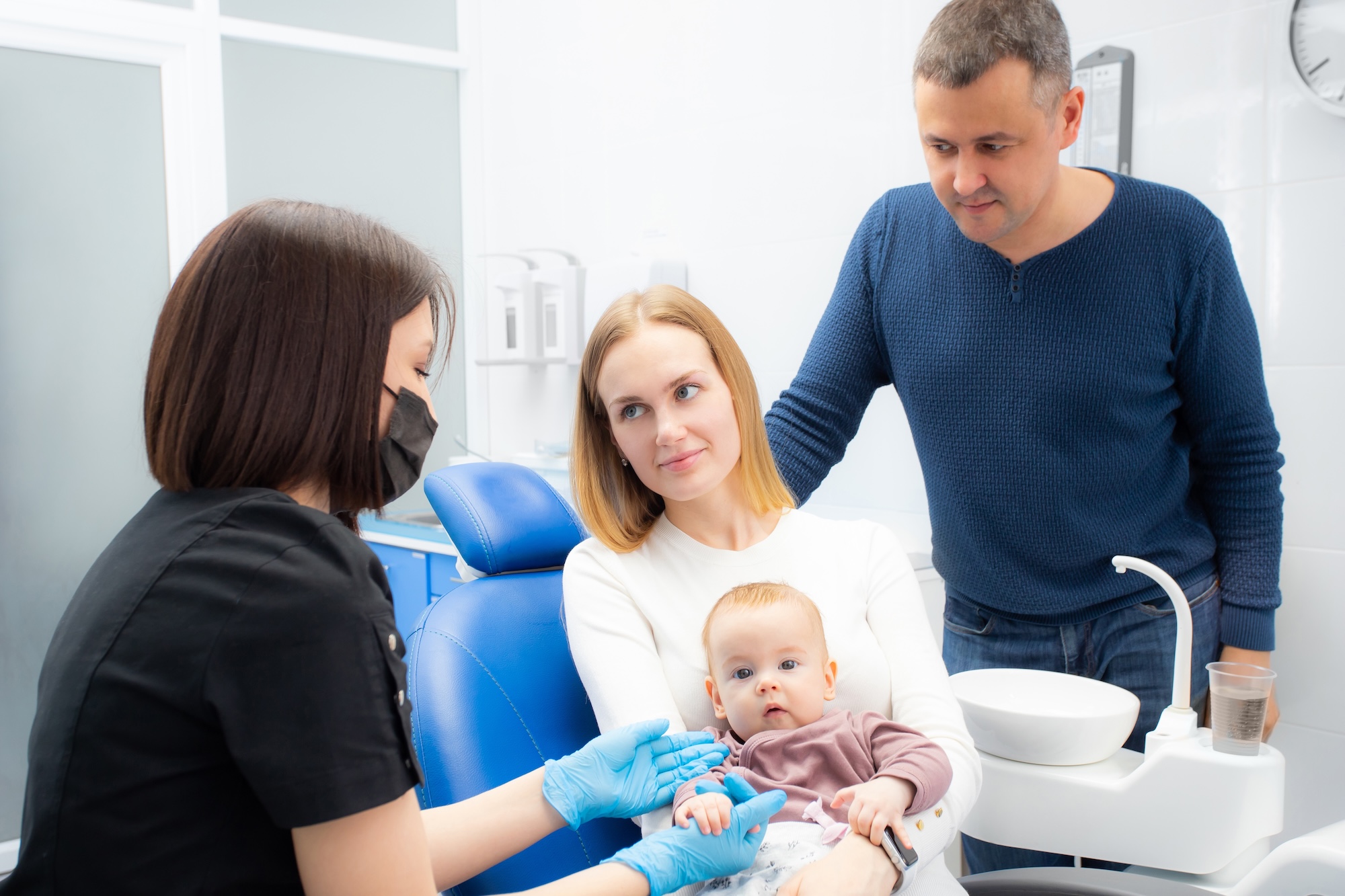 Image of a child giveing a high five to a dentist in Albuquerque
